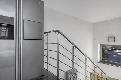 a staircase with a metal railing in a room at Contemporary apartment with rooftop terrace in Maribor in Maribor