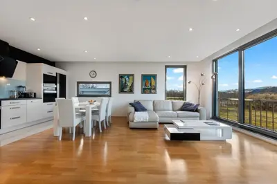 a living room with a couch and a table at Contemporary apartment with rooftop terrace in Maribor in Maribor