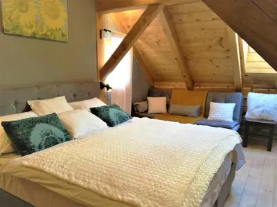 a bedroom with a large bed in a attic at LES CHALET Kranjska Gora DUPLEX in Kranjska Gora