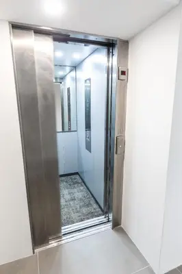 a glass shower door in a room with a mirror at Hiša OPERA in Maribor