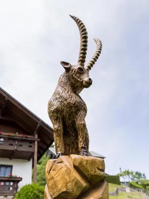 a statue of a goat standing on a rock at Alpinia apartments in Bled