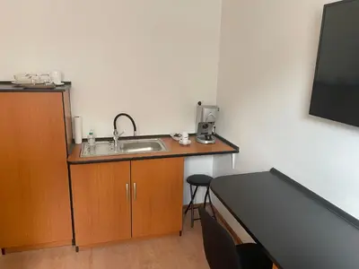 a bathroom with a sink and a bed in a room at Room AA in Dravograd