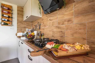 a kitchen counter with a cutting board with food on it at Vineyard Cottage Sončni grič in Trebnje