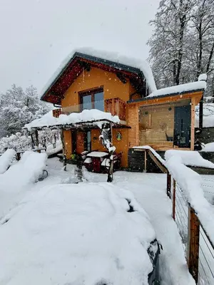a house covered in snow in front at Vineyard Cottage Sončni grič in Trebnje