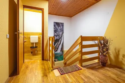 a room with a staircase and a hallway with a door at Farm Stay Trlej in Begunje na Gorenjskem