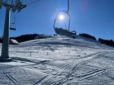 a ski lift in the air over a snow covered slope at Apartma Lilija Golte in Mozirje