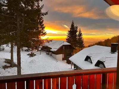 a winter view of a house with snow on the roof at Apartma Lilija Golte in Mozirje