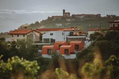 a group of houses sitting on top of a hill at Glamping Senesalina in Kojsko