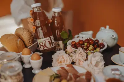 a table with eggs bread and bottles of syrup at Glamping Senesalina in Kojsko