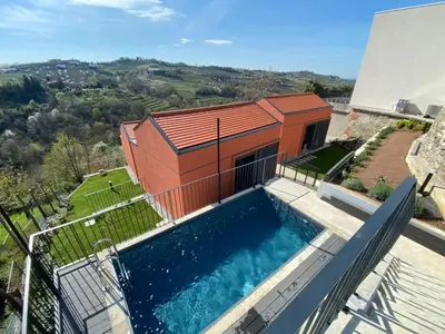 an overhead view of a house with a swimming pool at Glamping Senesalina in Kojsko