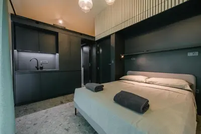 a bedroom with a large bed with a black headboard at Glamping Senesalina in Kojsko