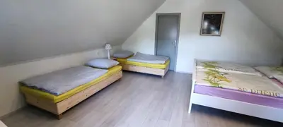 a room with two beds in a room at Wooden House Gabra in Podnart