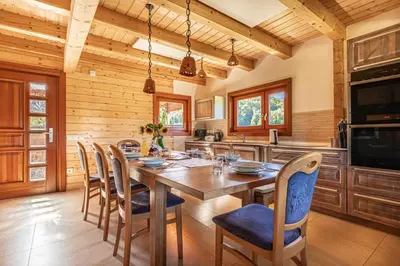 a dining room with a large wooden table and chairs at House Of Nature With Sauna And Tents - Happy Rentals in Planina pri Sevnici