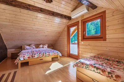 a bedroom with two beds in a log cabin at House Of Nature With Sauna And Tents - Happy Rentals in Planina pri Sevnici