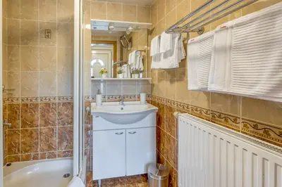 a bathroom with a sink and a toilet and a tub at River View Suite Mlinar Private Beach - Happy Rentals in Metlika