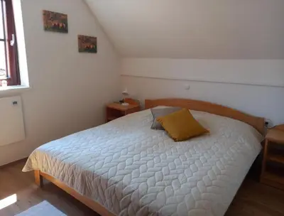 a bedroom with a bed with a yellow pillow on it at DEMI108 - Terme čatež - pool tickets included in Čatež ob Savi