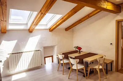a dining room with a wooden table and chairs at Toncevi Eco Estate in Branik