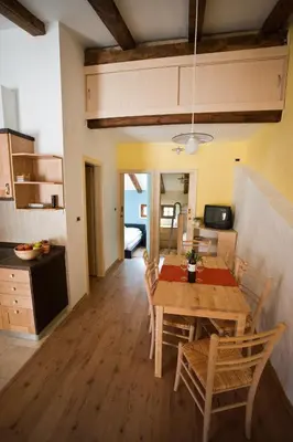 a kitchen and dining room with a table and chairs at Toncevi Eco Estate in Branik