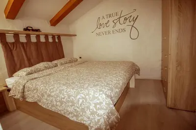 a bedroom with a bed and a sign on the wall at Toncevi Eco Estate in Branik