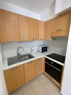 a small kitchen with a sink and a microwave at JZ Apartments - Pohorje in Maribor
