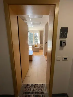 a hallway leading into a living room with a door at JZ Apartments - Pohorje in Maribor