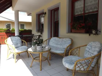a patio with chairs and a table and a table and chairs at Apartmaji Boštjan Pristavec in Kranjska Gora