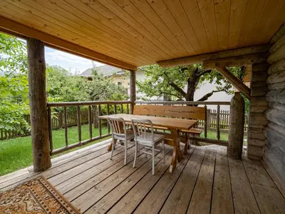 a wooden deck with a table and chairs on it at Chalet Sejalec in Lesce