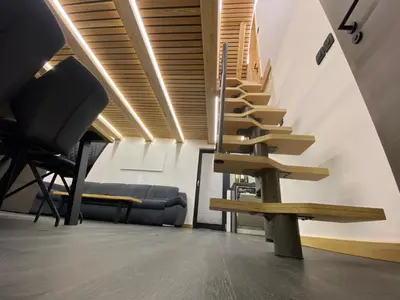 a staircase in a room with a bench and a couch at Brunarica Chalet Rogla Sauna in Vitanje
