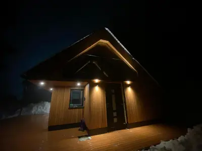 a small building with lights on top of it at Brunarica Chalet Rogla Sauna in Vitanje