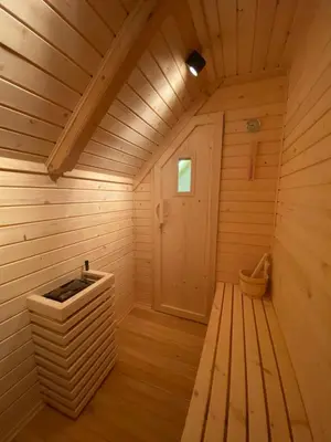 a wooden sauna with a tub in a room at Brunarica Chalet Rogla Sauna in Vitanje