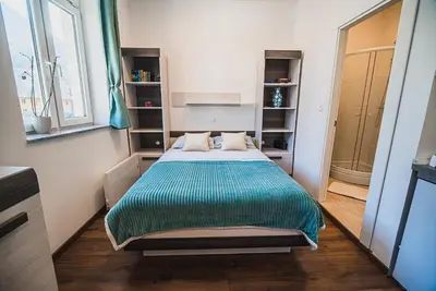 a small bedroom with a bed in a room at Studio CENTER in Zgornje Jezersko