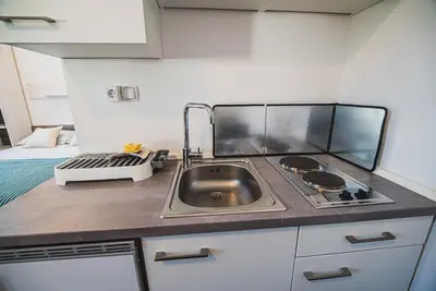 a small kitchen with a sink and a stove at Studio CENTER in Zgornje Jezersko