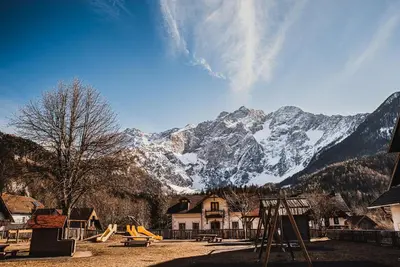a playground in front of a snow covered mountain at Studio CENTER in Zgornje Jezersko
