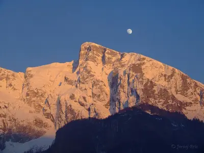a mountain with the moon on top of it at Apartma Mataj in Kobarid