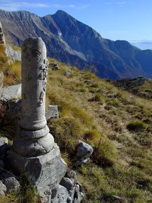 a stone monument on the side of a mountain at Apartma Mataj in Kobarid