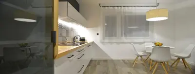 a kitchen with two white chairs and a sink at CITYMAP HOTEL APARTMENTS Maribor-Free parking! in Maribor