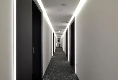 a hallway with black and white walls and lights at CITYMAP HOTEL APARTMENTS Maribor-Free parking! in Maribor
