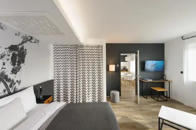 a bedroom with a bed and a desk and a television at CITYMAP HOTEL APARTMENTS Maribor-Free parking! in Maribor