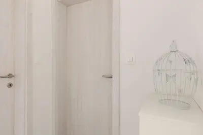 a bird cage on a wall next to a door at Deluxe Apartments 55 in Kranjska Gora