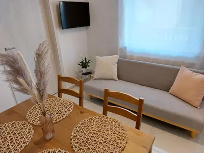 a living room with a couch and a table at Deluxe Apartments 55 in Kranjska Gora