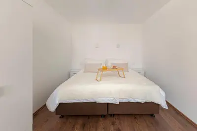 a bedroom with a bed with a wooden table on it at Deluxe Apartments 55 in Kranjska Gora