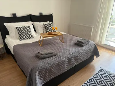 a bedroom with a bed with a table on it at Deluxe Apartments 55 in Kranjska Gora