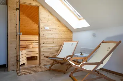 two chairs and a table in a sauna at BEe in foREST in Pivka