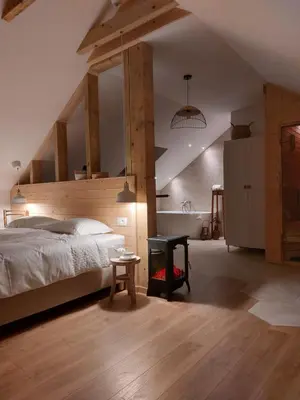 a bedroom with a large bed and a table at BEe in foREST in Pivka