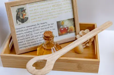 a wooden box with a bottle of oil and wooden spoons at BEe in foREST in Pivka