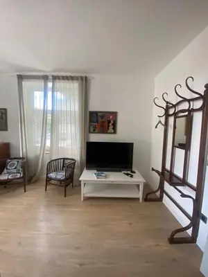 a living room with a tv and a table at NEW G&P Villa - Free Parking in Ljubljana