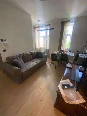 a living room with a couch and a table at NEW G&P Villa - Free Parking in Ljubljana
