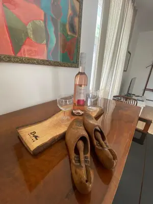 a pair of shoes and a bottle of wine on a table at NEW G&P Villa - Free Parking in Ljubljana