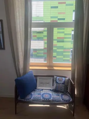 a laptop sitting on a bench in front of a window at NEW G&P Villa - Free Parking in Ljubljana