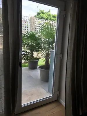 an open door with potted plants in a room at NEW G&P Villa - Free Parking in Ljubljana
